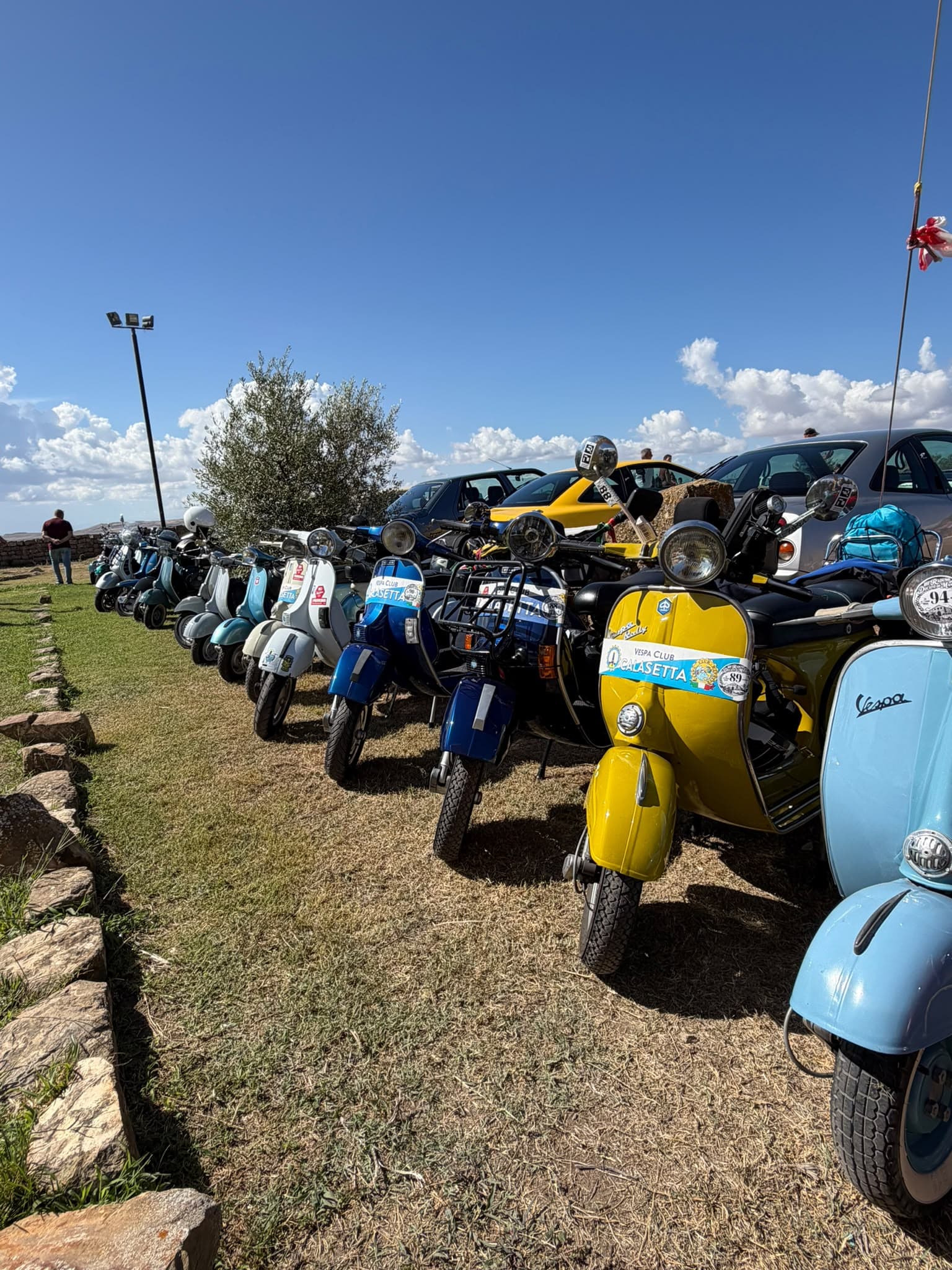 Vintage Vespas and classic scooters lined up at the Ducato di Mandas Rally