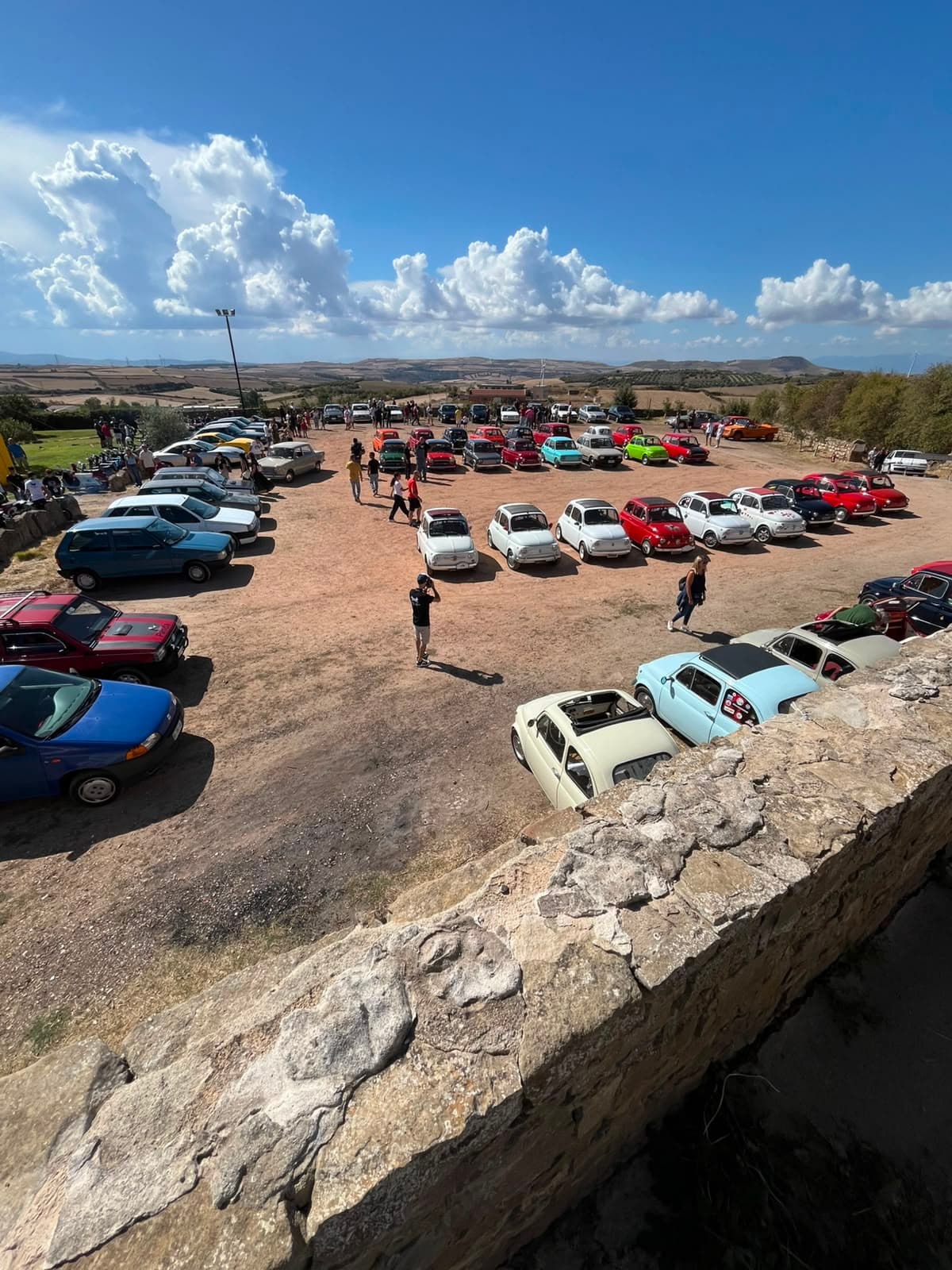 Aerial view of the Mandas square filled with vintage cars and visitors