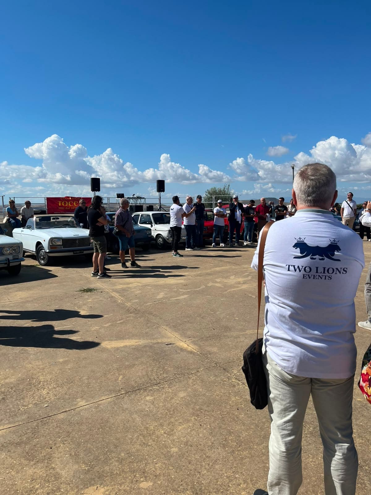 Team member wearing the official Two Lions Events polo shirt at the rally